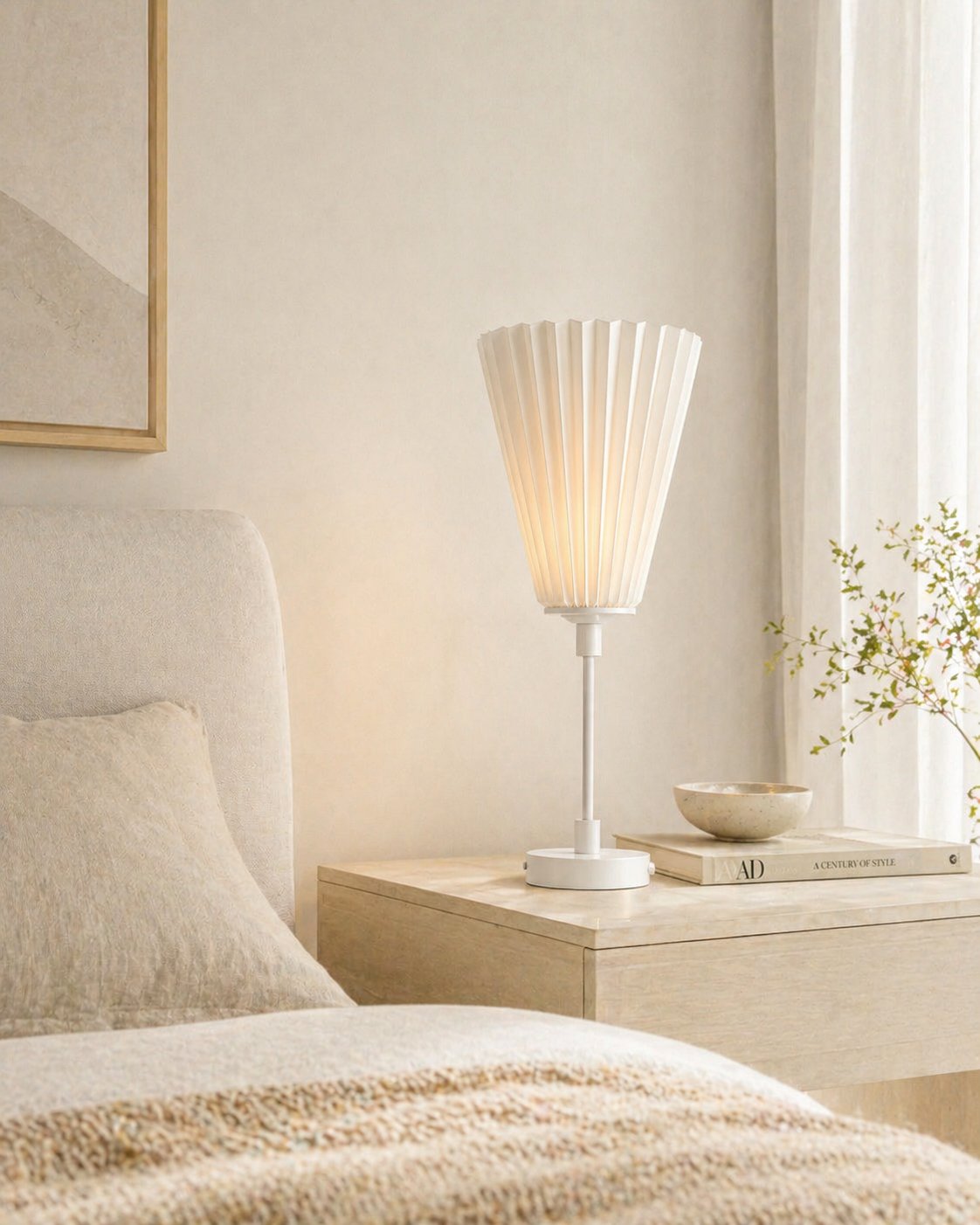 Bell-shaped pleated table lamp on a bedside table