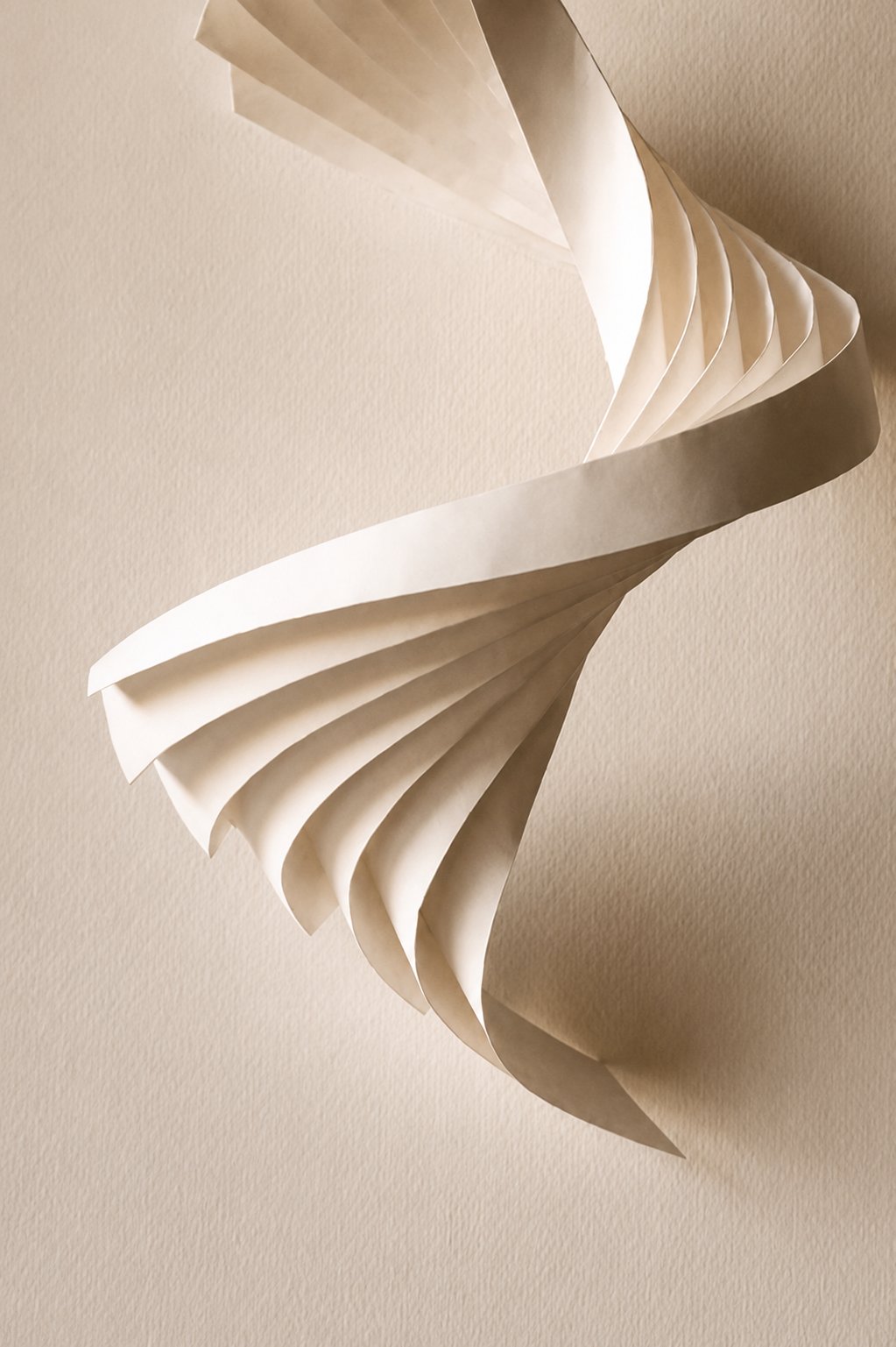Small twisting ribbon-like pleated paper sculpture